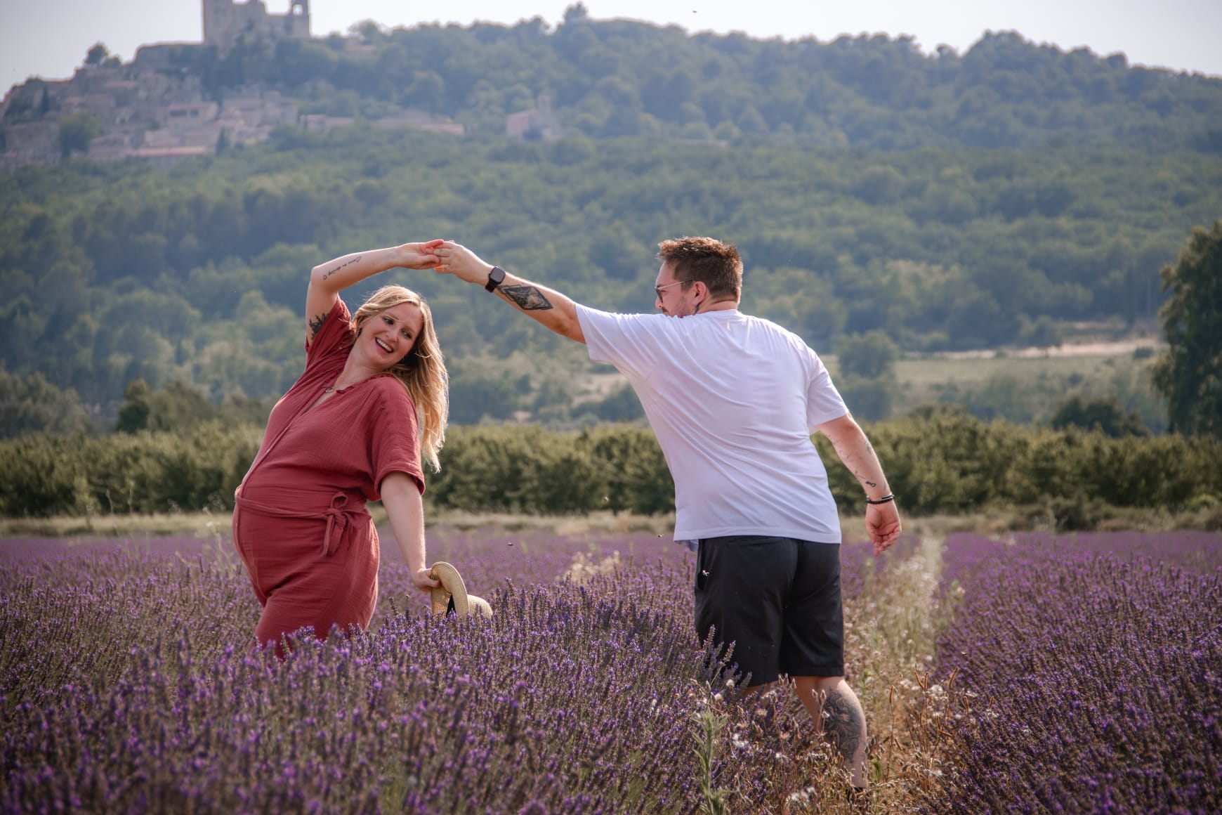 Maternity couple dancing in lavender field